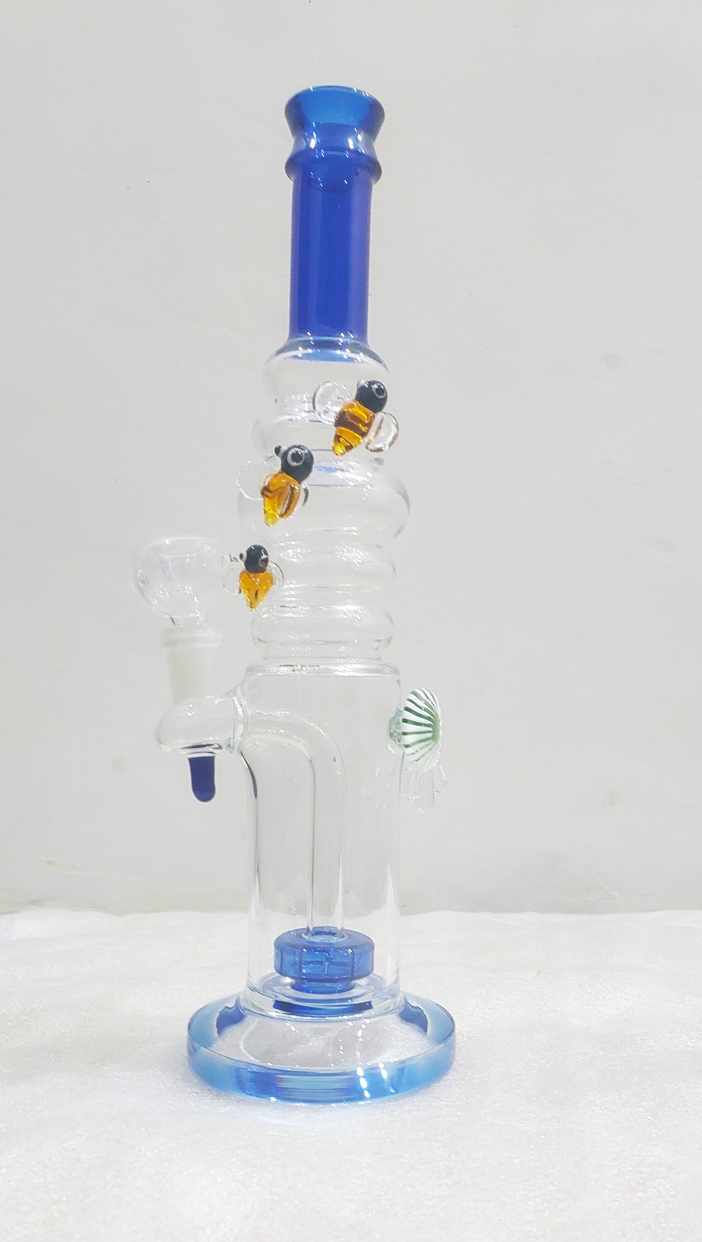 Glass water pipe with blue accents on a white background, Bees on Rings
Watching every bong rip
Heavy Borosil blow handcrafted glass piece with a Fish eye