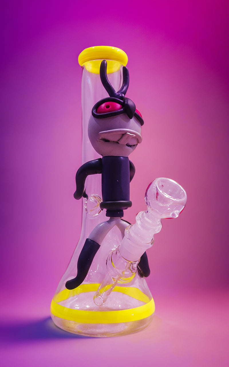 Close-up of a Trippy acid boy glass dick bong with yellow and black parts on a white background, instant delivery in delhi ncr, pan india smoking accessories brand theboomboxclub