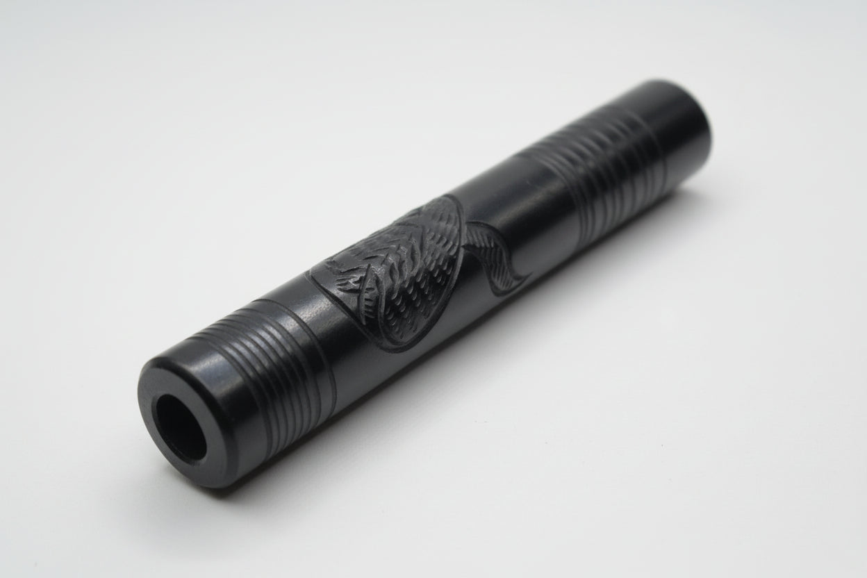 Black cylindrical object on a white surface