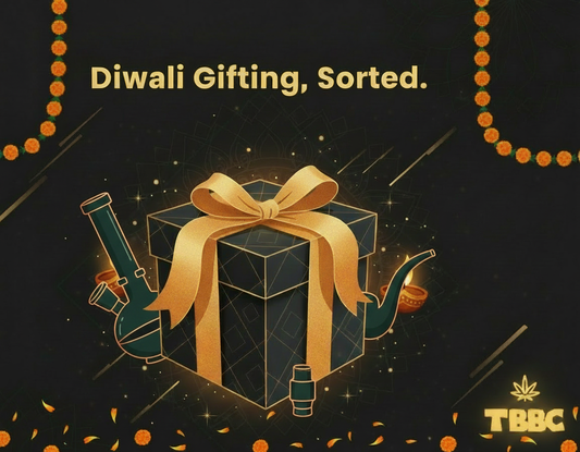 TBBC Diwali gift illustration with a gold-ribbon box, smoking accessories and marigold garlands on a dark background