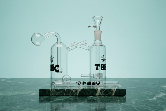 TBBC Classic mini glass rig, Pocket Sutra mini glass bong and Slym Shady glass one hitter together on a green marble platform