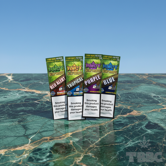 Juicy Jay’s assorted hemp wraps 4-pack with Red Alert, Tropical, Purple and Blue packs on marble and sky background