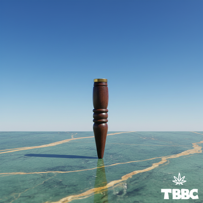 TBBC handcrafted big wooden filter tip with dark finish, brass ring, contoured grip and tapered end on marble and sky background