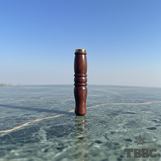 TBBC handcrafted big wooden filter tip in dark finish with brass ring and contoured body on marble and sky lifestyle background