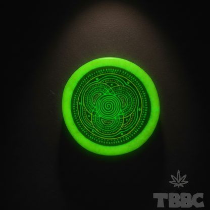 Glow Crushing Bowl glowing under UV light, showing its bright green finish and geometric surface pattern.
