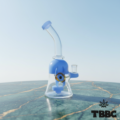 Mini dab rig 8 inch with 14mm joint, clear glass and blue nazar eye detail on marble and sky background