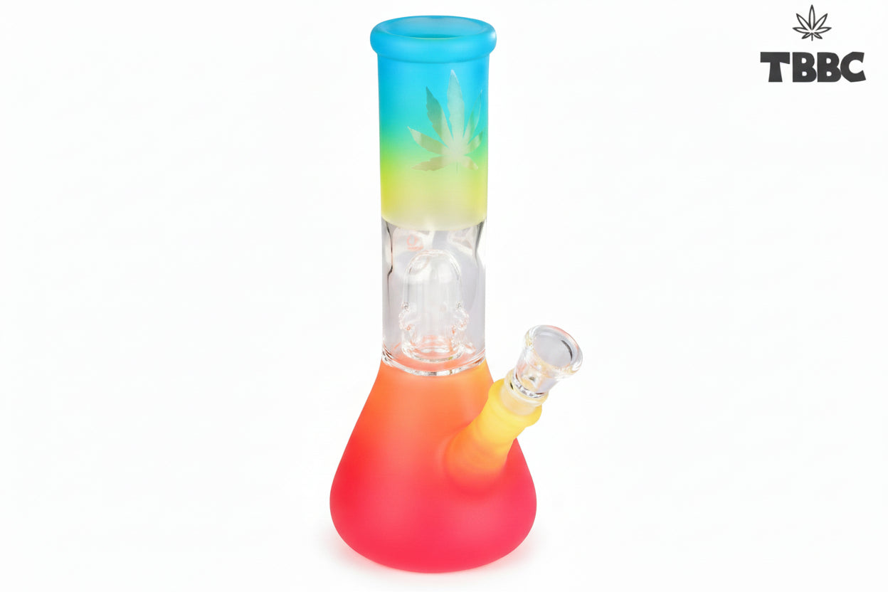 A colorful glass percolator ice bong with a clear base and multicolored upper part, featuring ice cubes inside and a blue lid. Instant delivery delhi ncr, exporter for quality glass bongs india