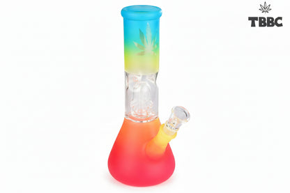 A colorful glass percolator ice bong with a clear base and multicolored upper part, featuring ice cubes inside and a blue lid. Instant delivery delhi ncr, exporter for quality glass bongs india