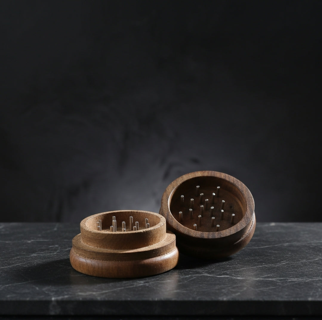 Open TBBC Signature 56mm wooden herb grinder showing the interior chamber and grinding pegs against a dark backdrop.