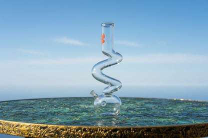 Clear glass spiral beaker on a white background, zig zag bongs india, bongs instant delivery delhi ncr, exporter for bongs in india, supplier for bongs in canada europe germany australia france italy, best bongs supplier in PAN INDIA