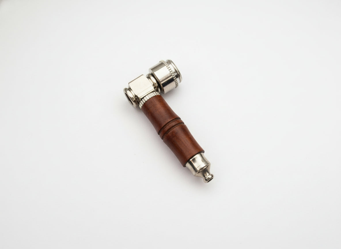 Small tool with a brown handle and metallic end on a light gray background, raw wood metal smoking weed hand pipe, easy to carry and clean smoking pipes for export, wholesale smoking pipes manufacturer, quality smoking pipes online instant delivery 