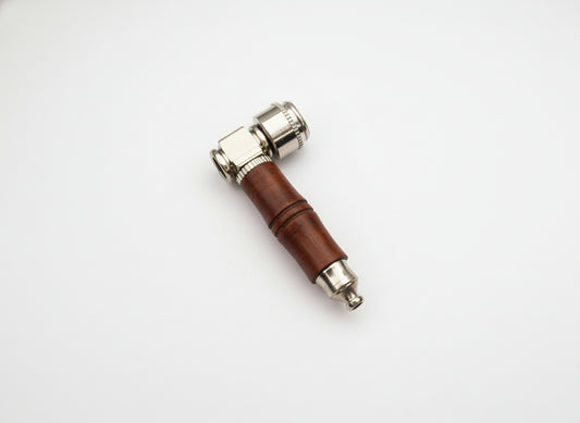 Small tool with a brown handle and metallic end on a light gray background, raw wood metal smoking weed hand pipe, easy to carry and clean smoking pipes for export, wholesale smoking pipes manufacturer, quality smoking pipes online instant delivery 