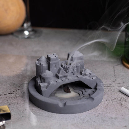 A gray Cosmic City Ashtray with a cityscape design, featuring a bridge and buildings, where smoke is intended to be released. Budget friendly durable cost efficient reasonable quality greyt ashtrays, cigarette weed joint rolling paper bong ashtray