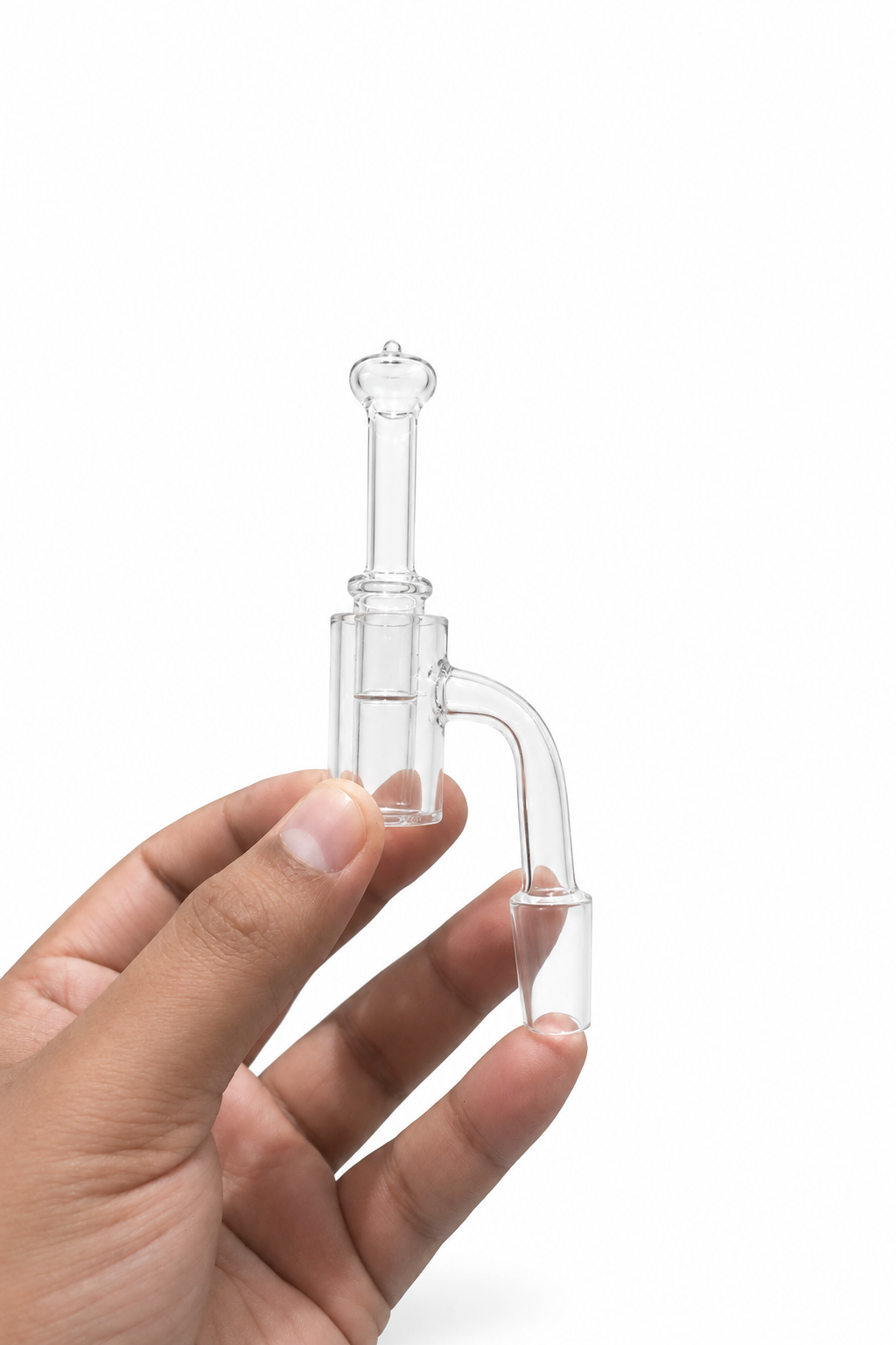 Clear quartz glass banger with carb cap held in a hand against a clean white studio background.