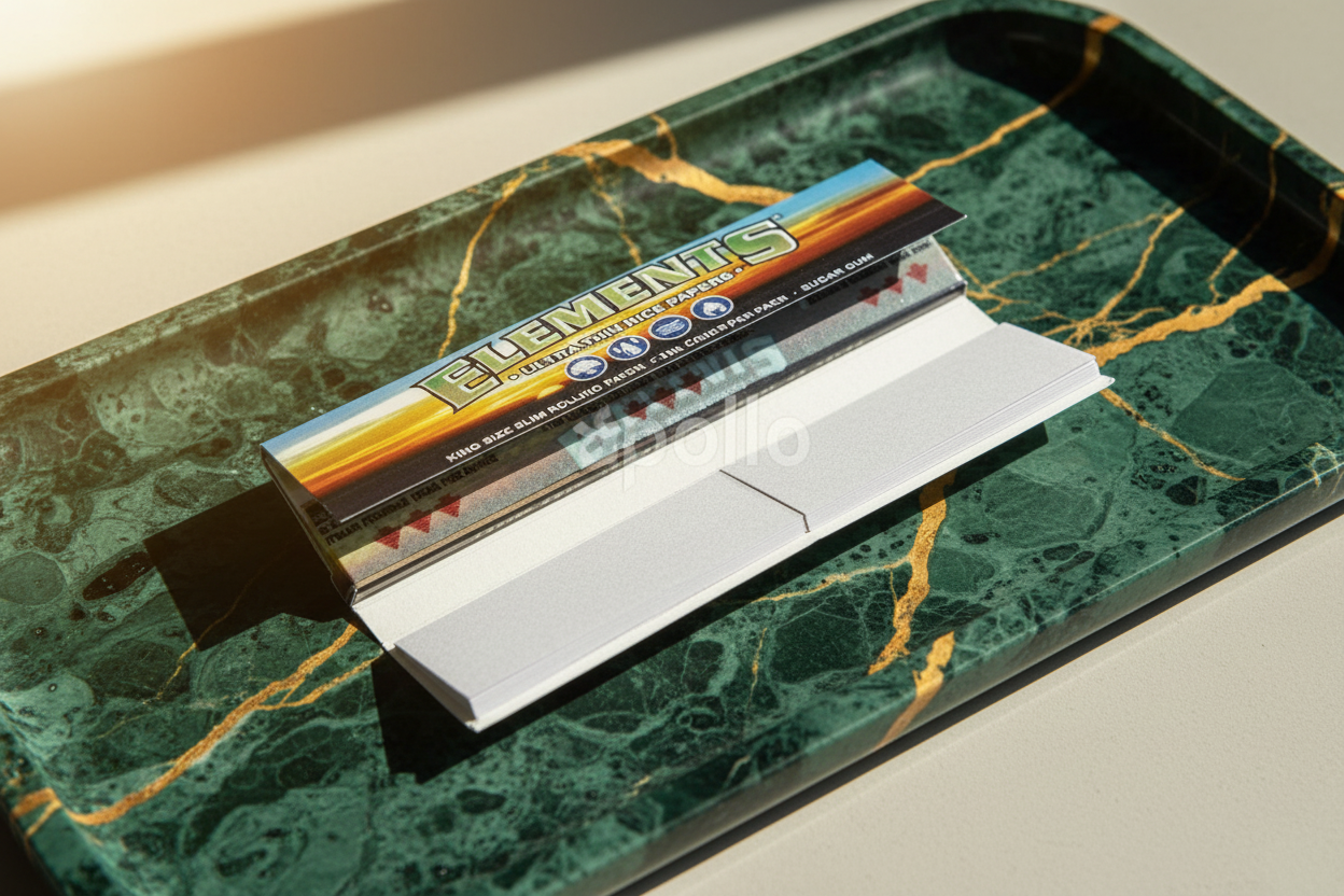 Packaging for Elements Connoisseur Paper Booklet with magnetic closure, featuring the brand's logo and design elements in gold and blue.