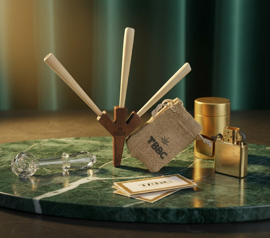 Collection of smoking accessories on a green marble surface with a blurred background, tbbc trident wooden joint holder