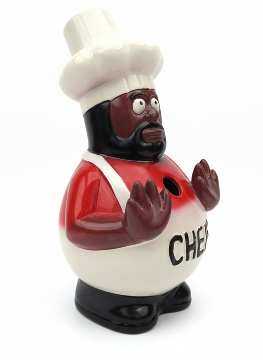 Chef-shaped water pipe with a red shirt, white hat and apron, black beard and raised hands, shown against a white background.