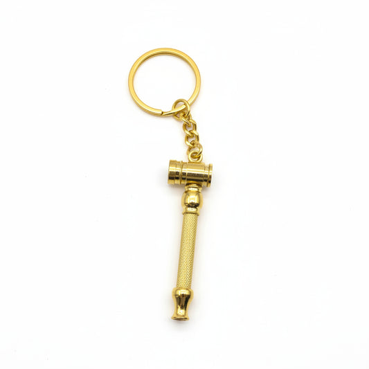 Gold key-shaped keychain on a light gray background, golden key chain smoking easy to carry hand pipe for weed, tobacco, smoking hand pipes for instant delivery, top notch quality metal brass smoking pipes exporter, trust worthy online smoke shop