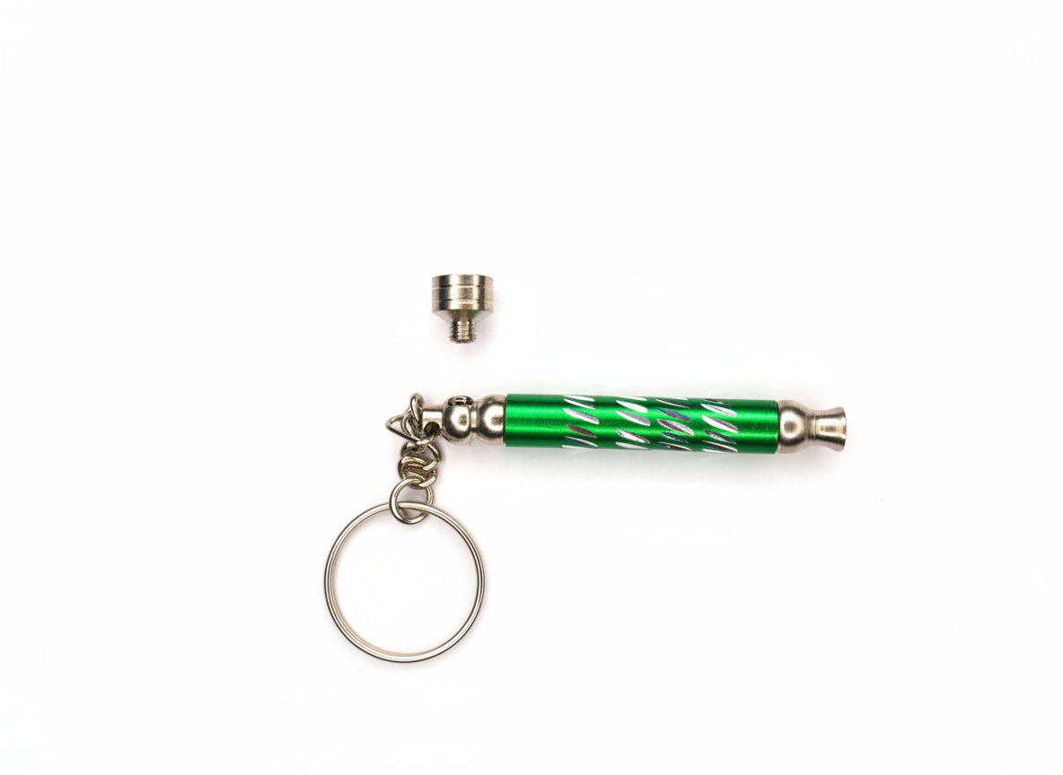 Green and silver keychain with a small metal component on a gray background, smoking weed handy metal key ring pipe for stoners 420 hippie culture export quality hand pipes