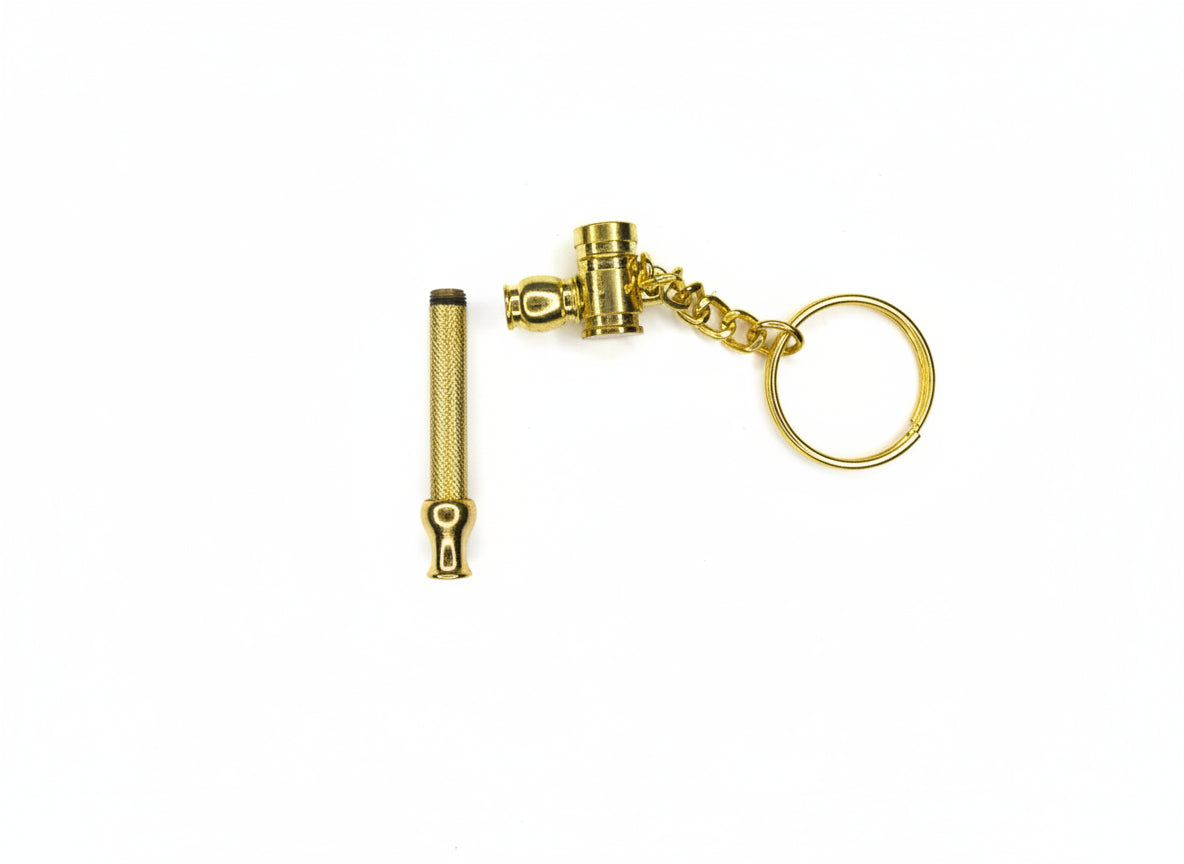 Gold keychain with attached tool on a gray background,Gold key-shaped keychain on a light gray background, golden key chain smoking easy to carry hand pipe for weed, tobacco, smoking hand pipes for instant delivery, top notch quality metal brass smoking pipes exporter, trust worthy online smoke shop