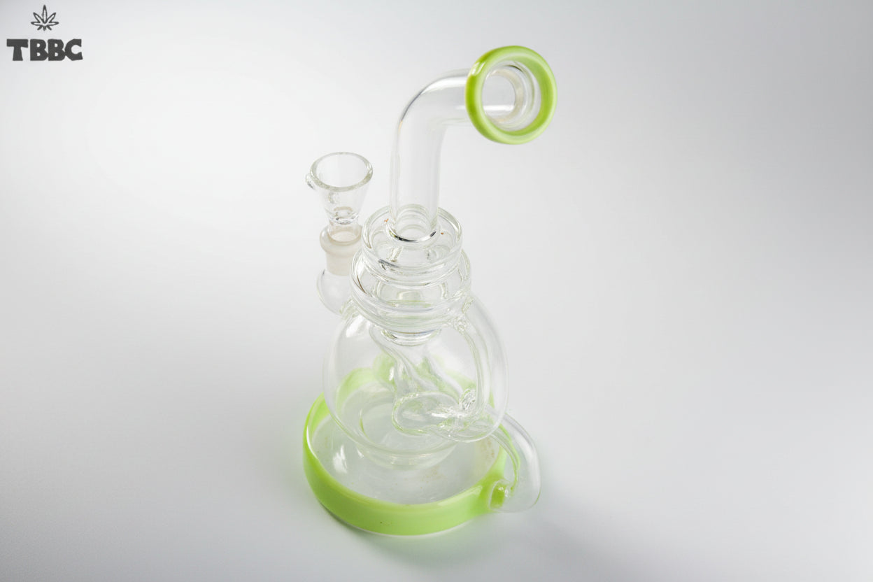 Glass smoking device with green accents on a white background, featuring the TBBC logo. exporter of bongs india, super quality bongs collection online