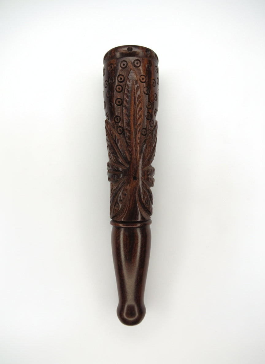 Decorative wooden object with intricate carvings on a white background, rosewood ganja chillum nearby me, top quality sadhu chillum online available at theboomboxclub, 7 inch wooden heavy weed leaf maruijane chillum instant delivery and export