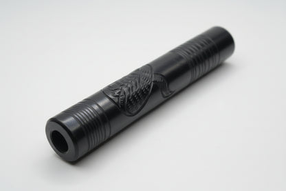 Black cylindrical object on a white surface