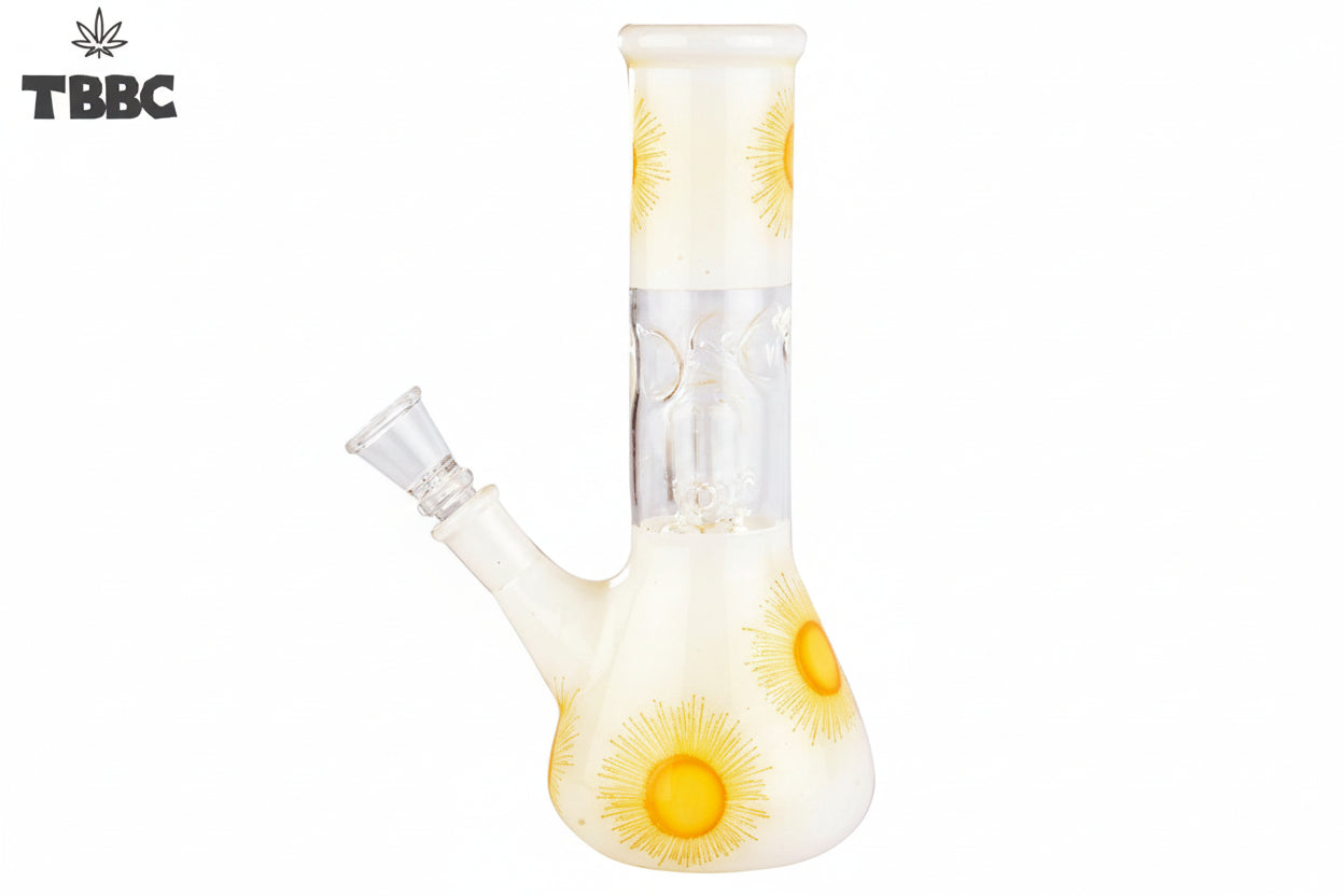 A beige-colored glass bong with a sunburst pattern, featuring yellow and orange hues, and ice spikes on the side.