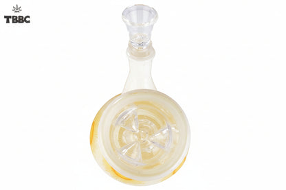 A beige-colored glass bong with a sunburst pattern, featuring yellow and orange hues, and ice spikes on the side, top view.